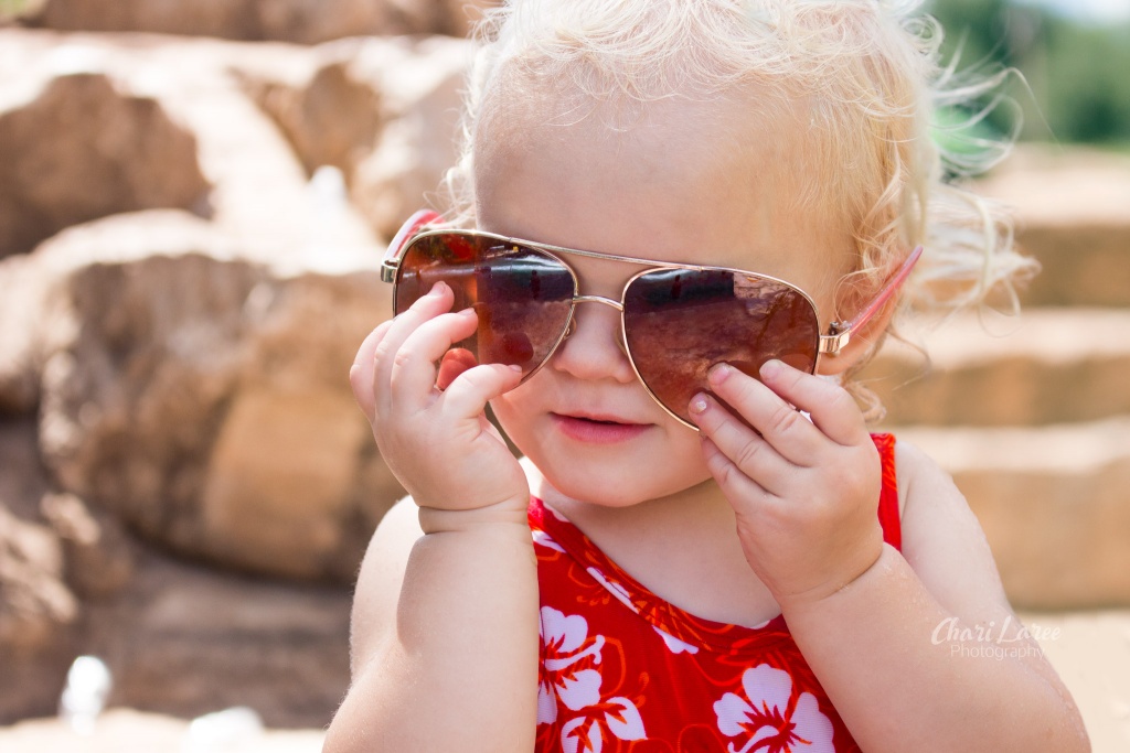 Baby at the beach with sunglasses on