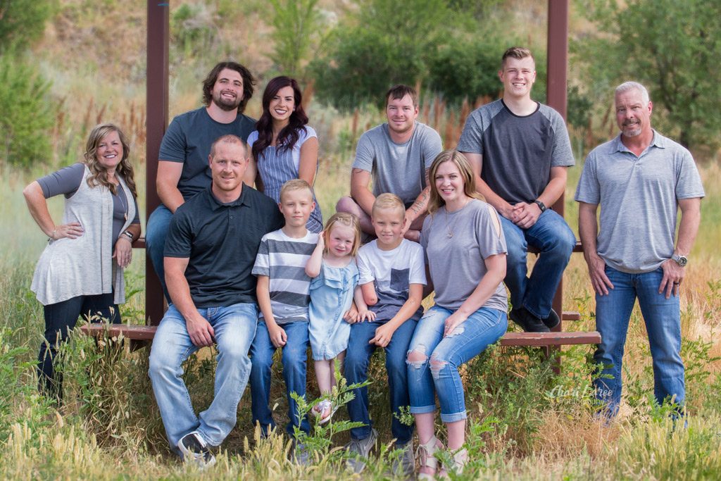 Family group sitting on a bench outside